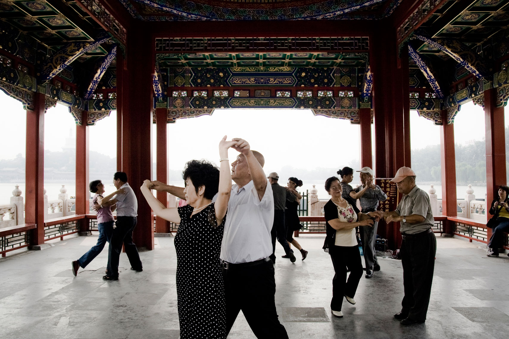 CHINA. Beijing, September 2012. People dance in Beihai Park. Chinese people gather in parks and public spaces to enjoy mutliple activities such playing cards, dancing, exercising, tai-chi practicing.